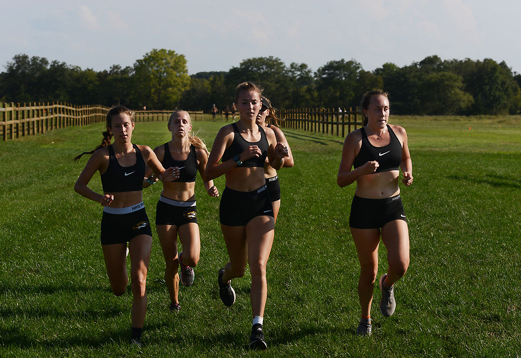 Members of MU's womens cross country team race toward the finishing line